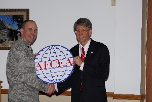 In March, Lt. Col. Steve Bailey, USAF (l), chapter president, presents Barton Clements, director of the 75th Air Base Wing Communications Directorate, with a chapter coin.